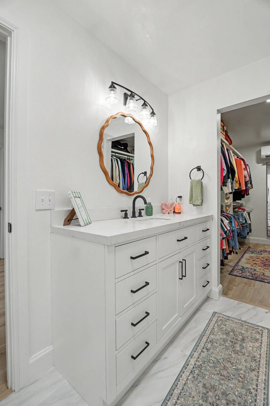 White shaker vanity with round mirror in the attic bathroom