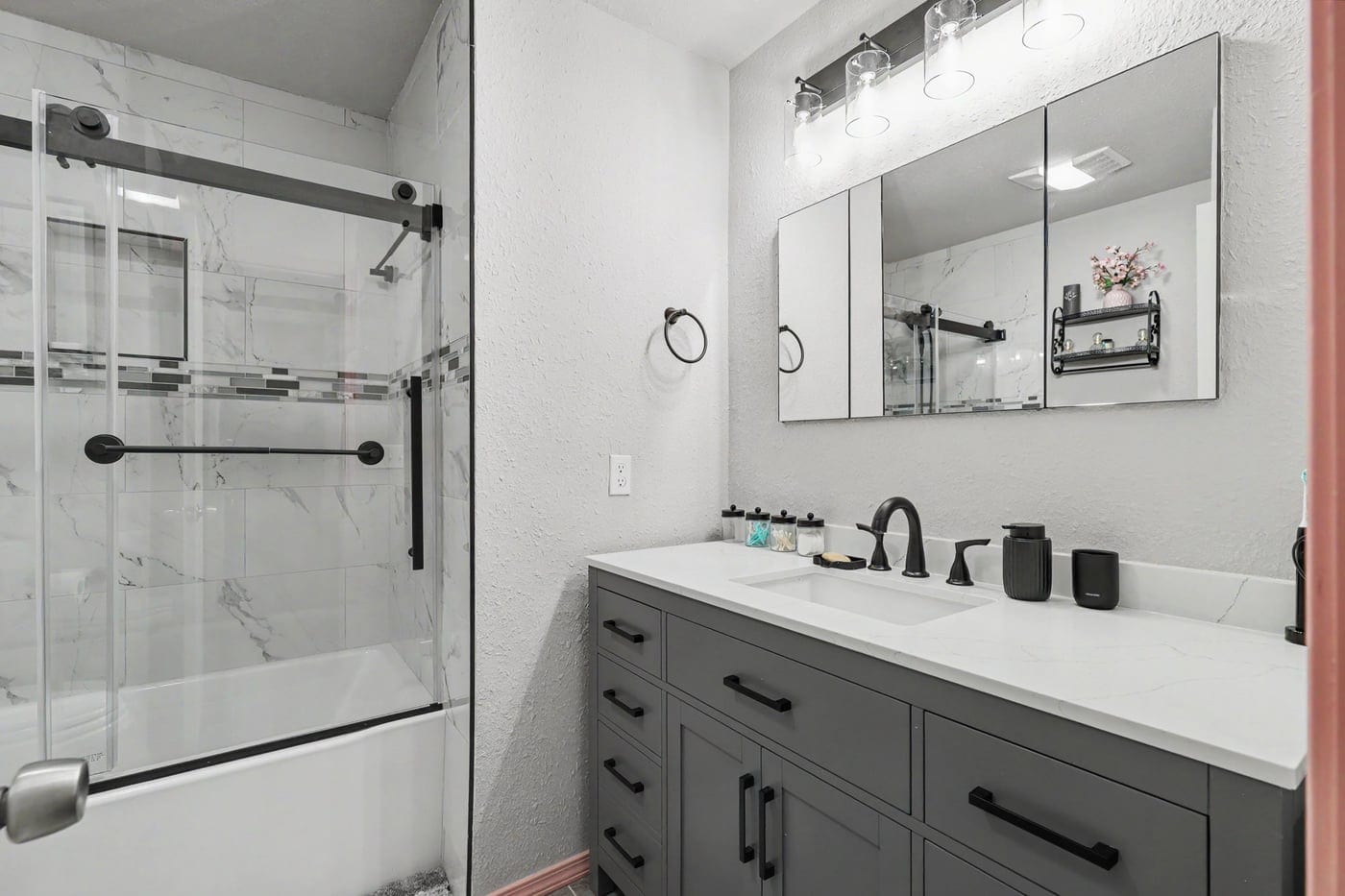 Second bathroom remodel with gray vanity and glass tub enclosure