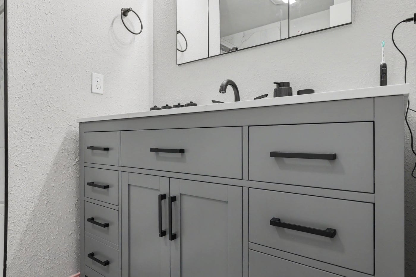 New gray shaker vanity with matte black hardware