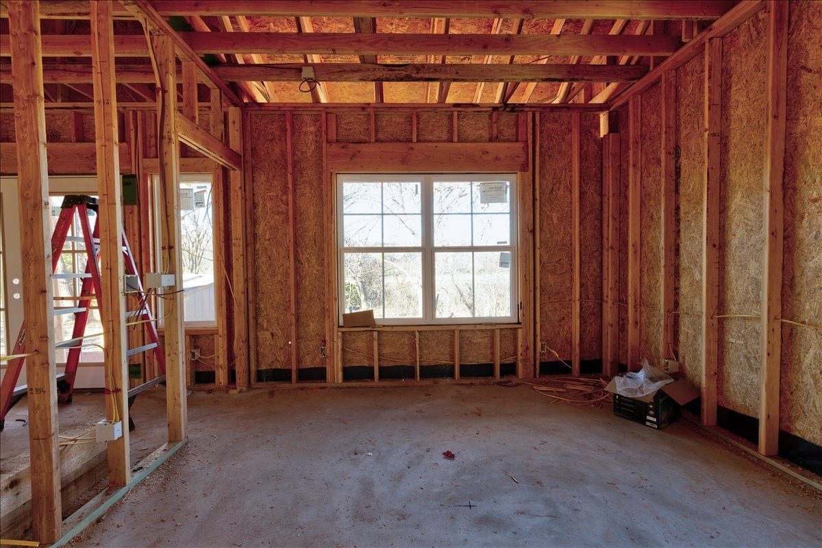 Framed guest house interior with new windows