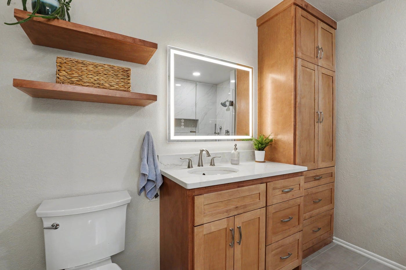 Wood shaker vanity with linen tower and lighted mirror